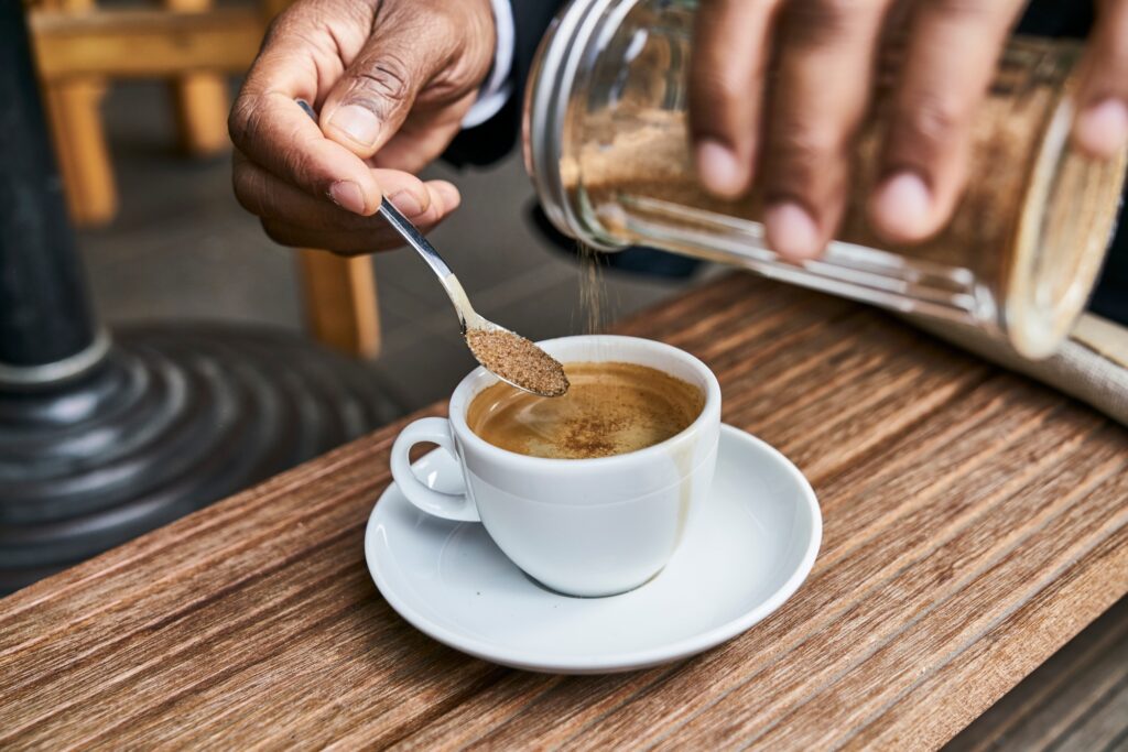 Man sitting in cafe, drinking coffee
